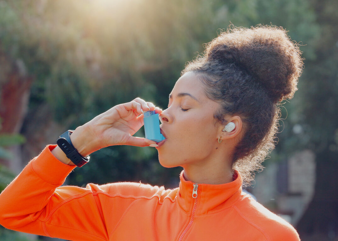 Fitness, asthma and running with a sports woman outdoor for a workout to improve health or cardio. Exercise, breathe and training with a young runner or athlete outdoor in the park for a challenge